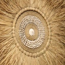 Wall decoration made of grass, rope and shells